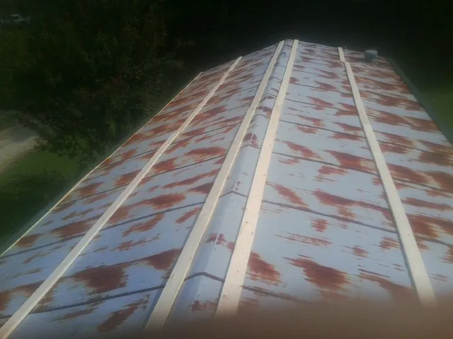 Rusted metal roof panels with new wood purlins before replacement — Storm Damage Roof Repair in Speed by Roofing Brothers