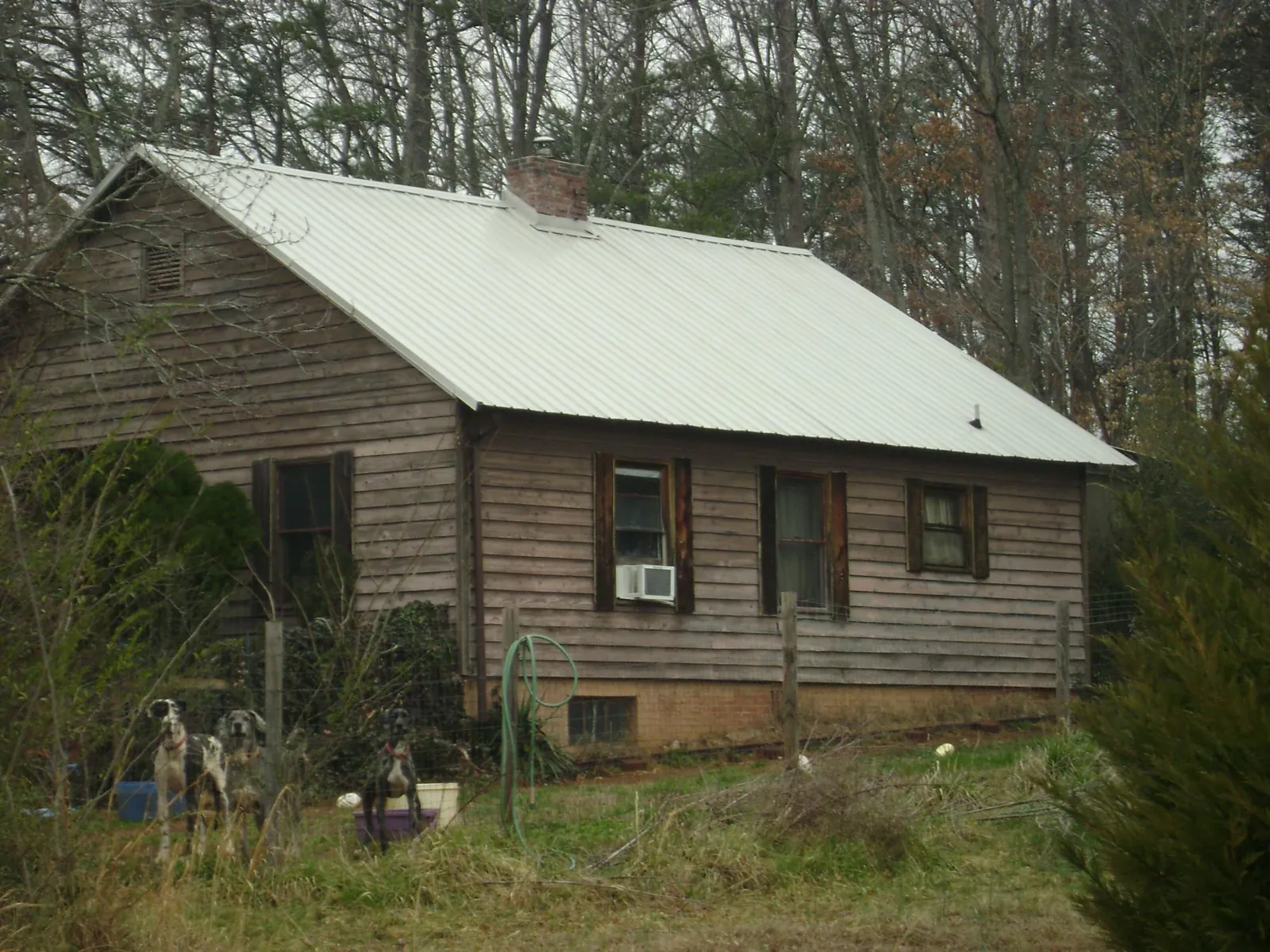White metal roof on an old wood sided farmhouse, from a Asphalt Shingle Roof Repair job in Speed